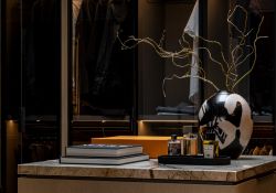Dream closet featuring smoked glass cabinetry with vertical LED illumination built in