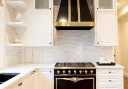 kitchen design with black and gold hood fan and stove