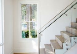 modern staircase with glass panel and stainless steel railing