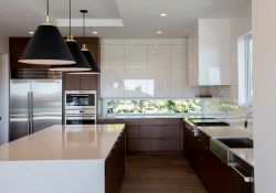 modern, clean lined kitchen design with a mix of glossy white and darker wood cabinets