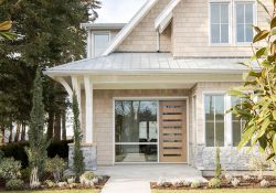 Light exterior of a custom home with traditional and modern elements